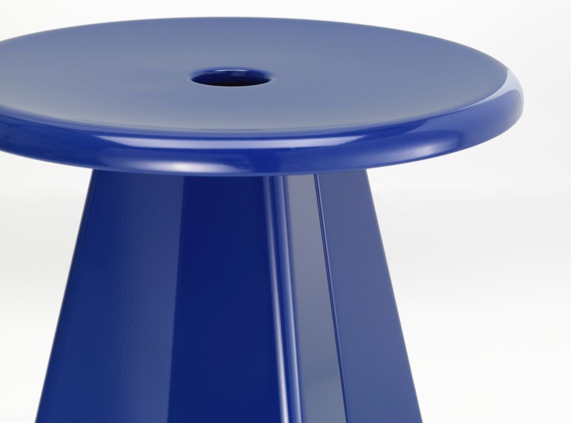 Nahaufnahme des blauen Vitra Tabouret Métallique Hockers mit runder Sitzfläche und konischem Fuß.
