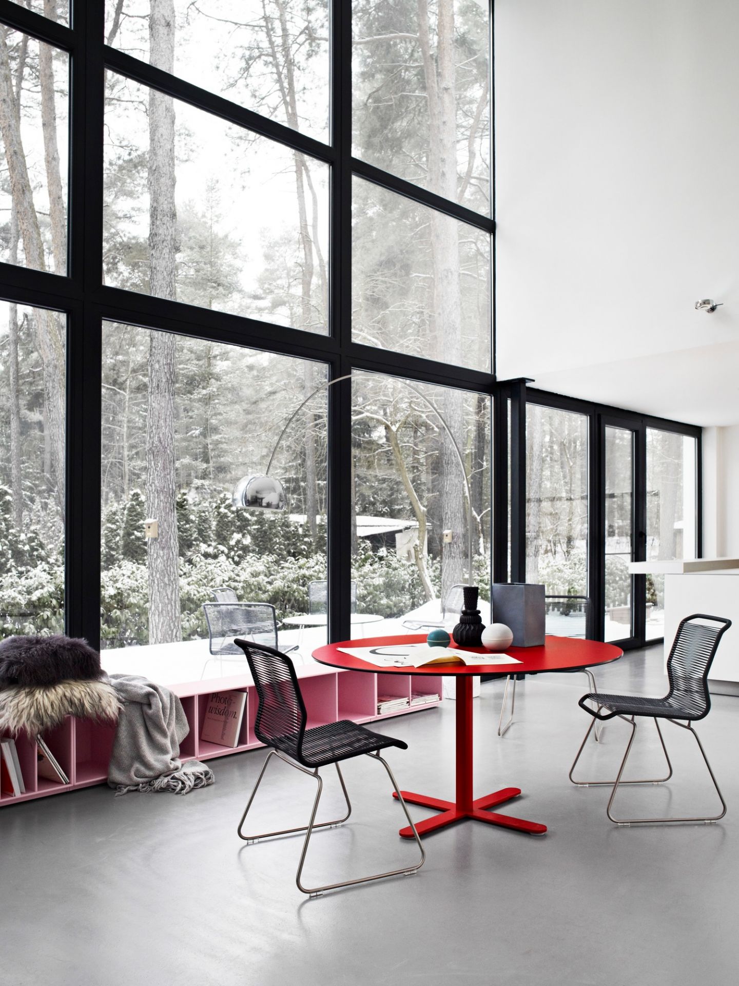 Panton One Dining Stuhl Outdoor Clark, Edelstahlgestell, vor großem Fenster mit Winterlandschaft, roter Tisch.