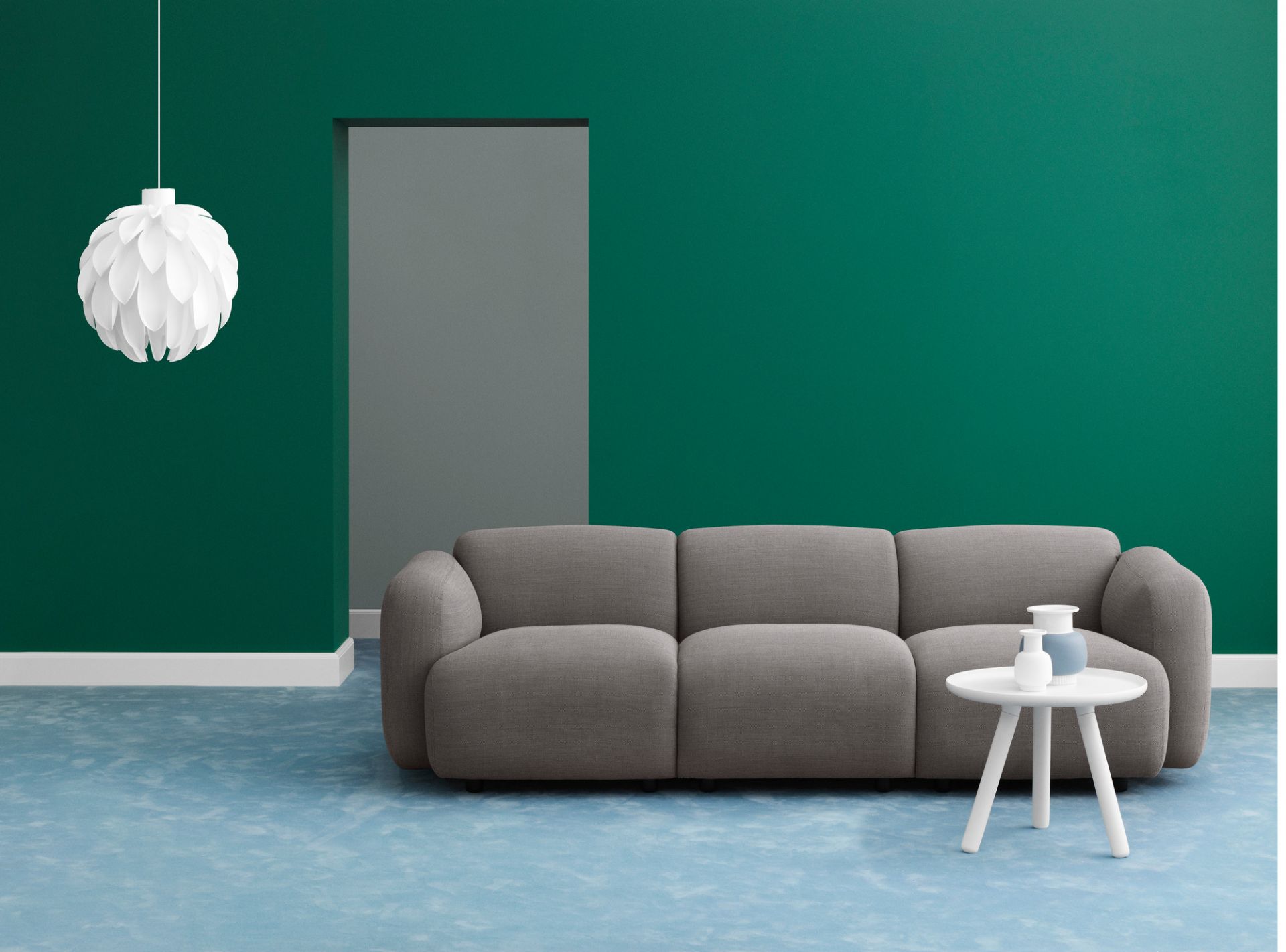 Normann Copenhagen Tablo Table Large Couchtisch in Weiß vor grauem Sofa und grüner Wand.
