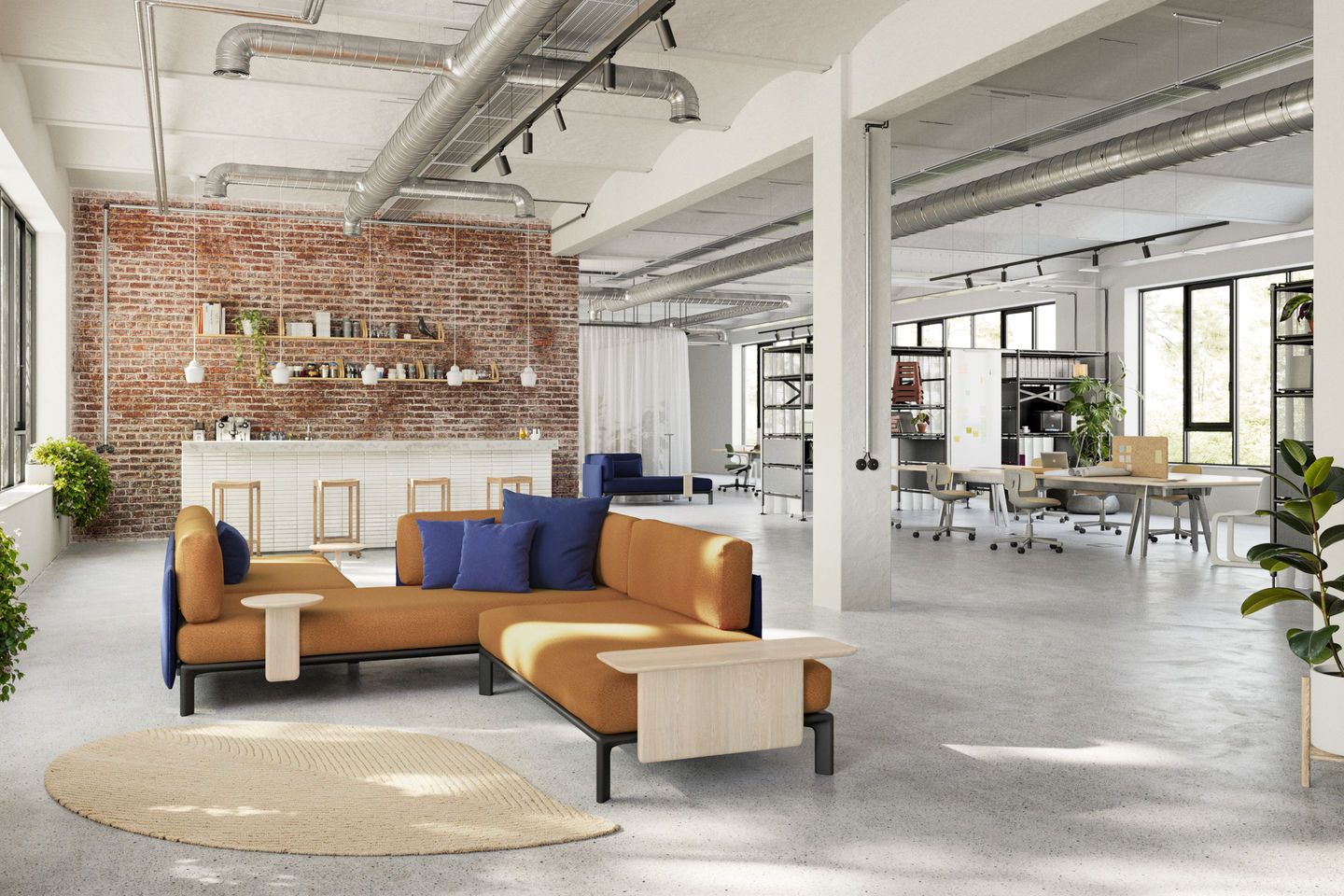 Vitra Anagram Sofa Plattform in orange mit blauen Kissen in einem modernen Büro.