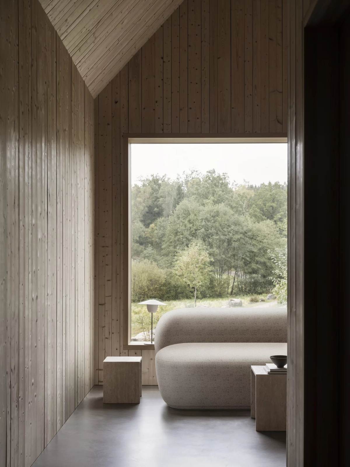 Beiges Kuon 2-Sitzer Sofa von Blomus in modernem, hellem Holzhaus mit Blick in die Natur.
