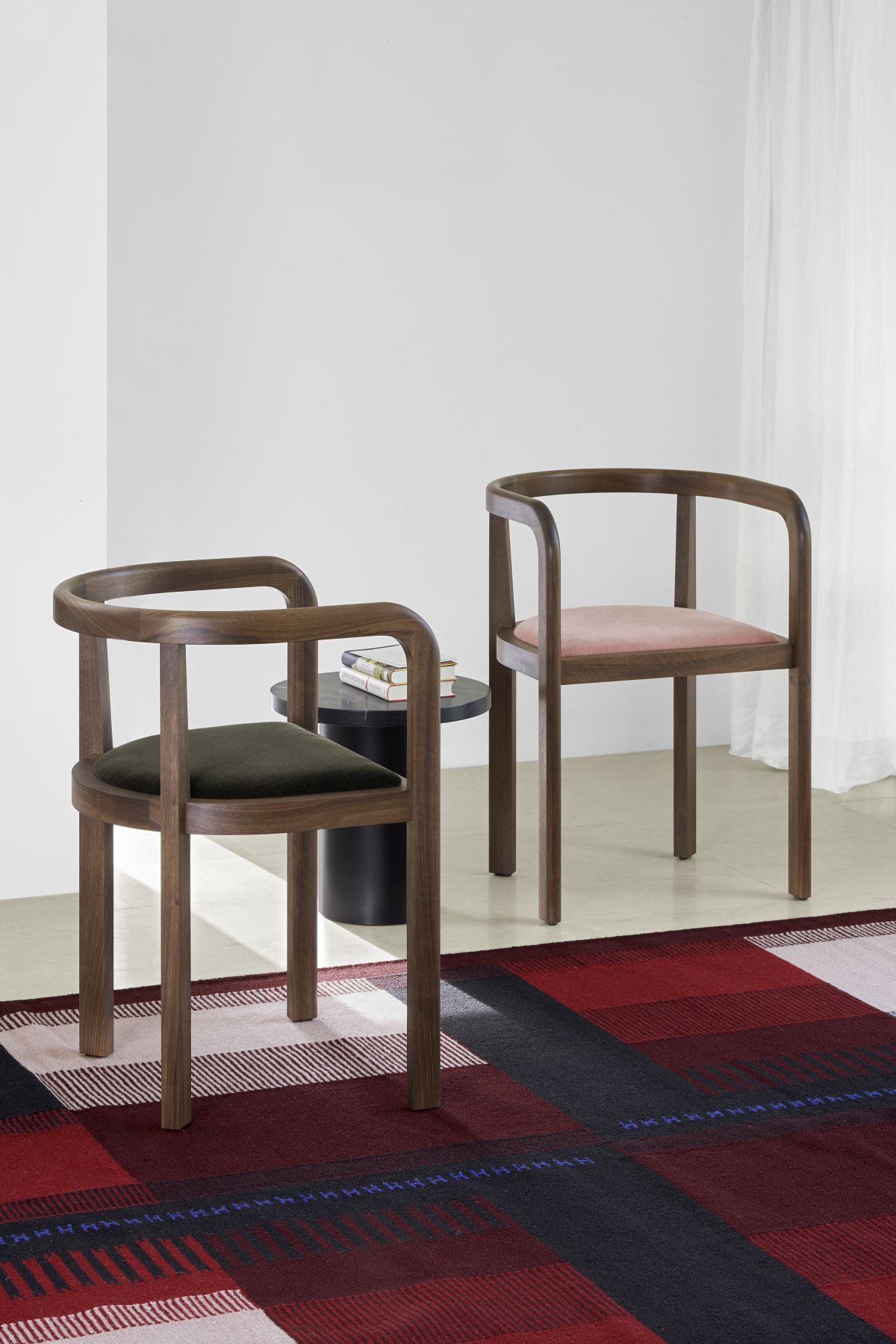 Zwei e15 Sessel aus Holz mit farbigen Sitzflächen und Enoki Beistelltisch im modernen Wohnzimmer.