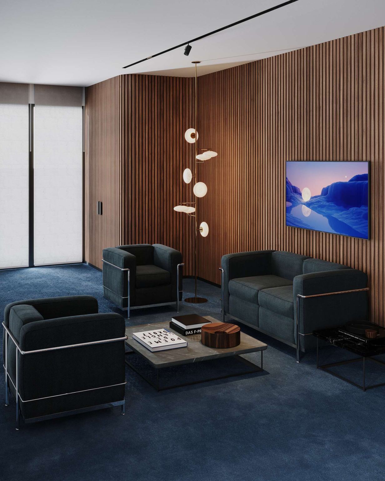 Wohnzimmer mit Cassina Tisch, Sesseln und Sofa in dunklem Blau auf blauem Teppich.