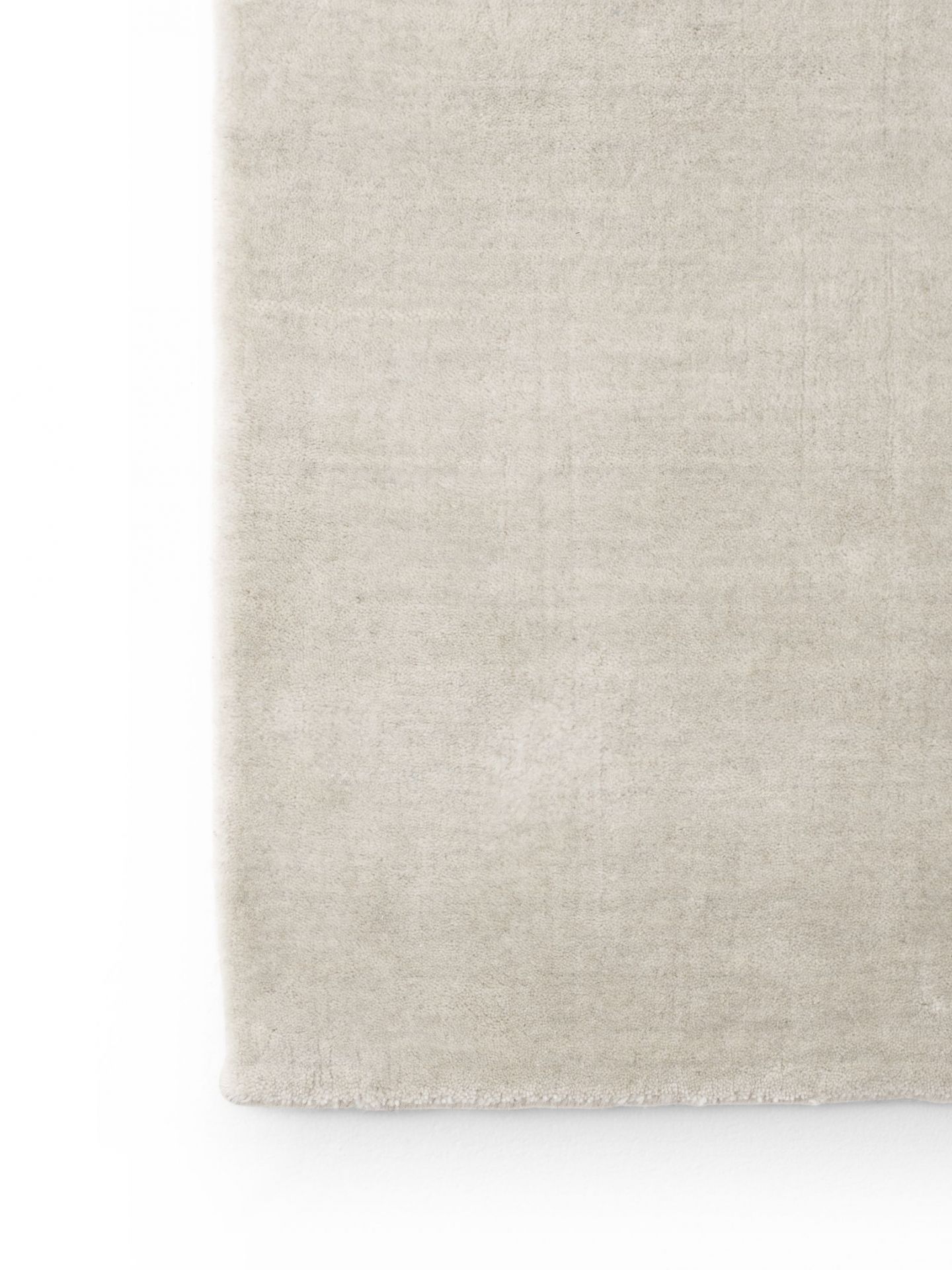 Detailaufnahme des Vipp Wollteppichs in Beige, handgeknüpfter Teppich aus Wolle und Bambus für Wohnzimmer und Schlafzimmer.