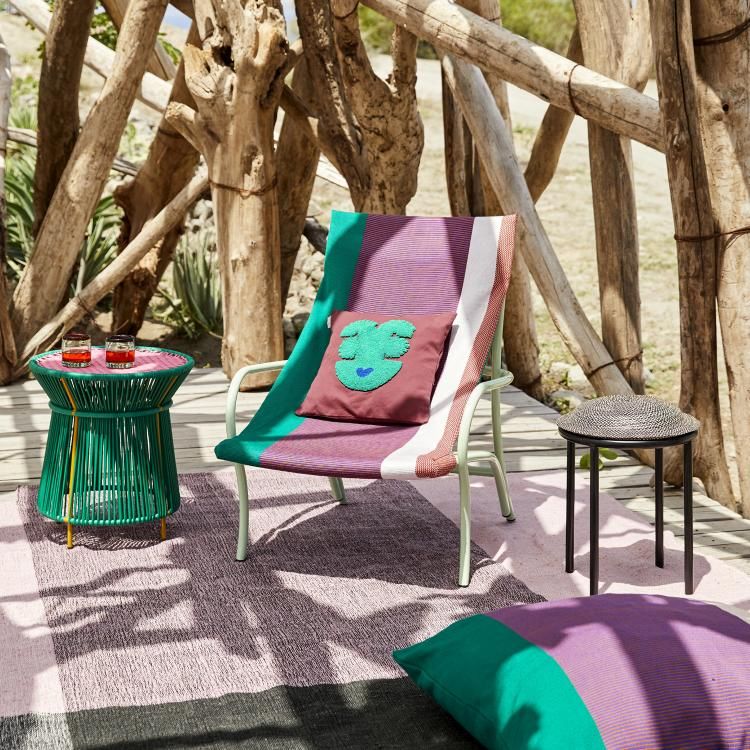Caribe Beistelltisch in Grün neben Liegestuhl und Teppich im Outdoor-Bereich. Gartenmöbel und Dekoration.