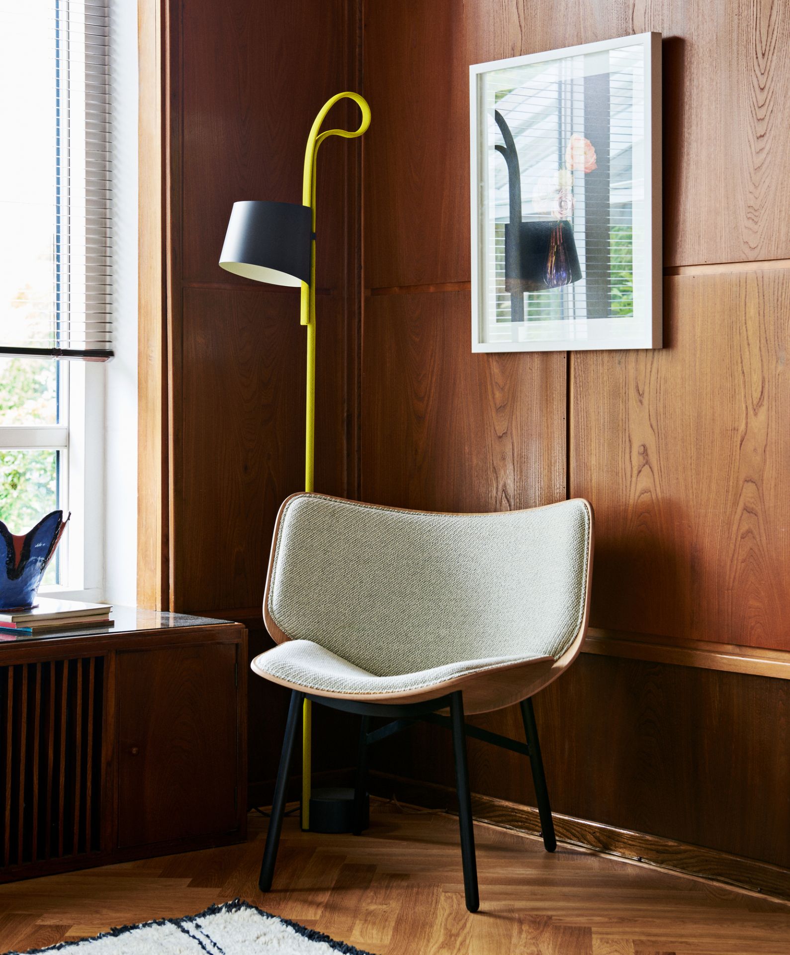 Dapper Lounge Chair Sessel von Hay mit hellgrauem Bezug und schwarzem Gestell vor Holzvertäfelung.