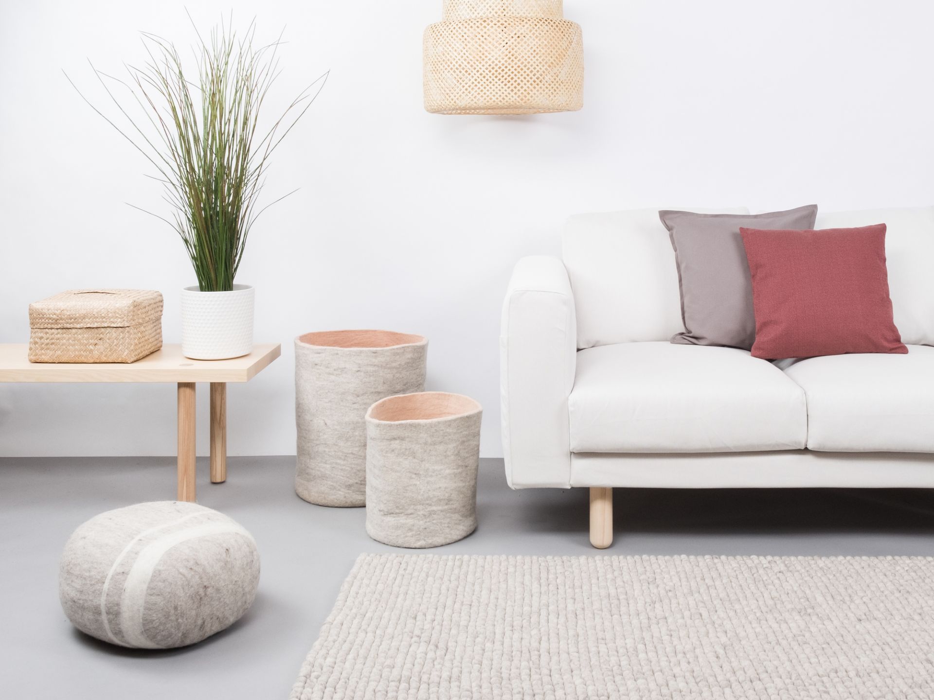 myfelt Filzkugel Teppich 120x170 cm in hellem Grau im modernen Wohnzimmer mit Sofa.
