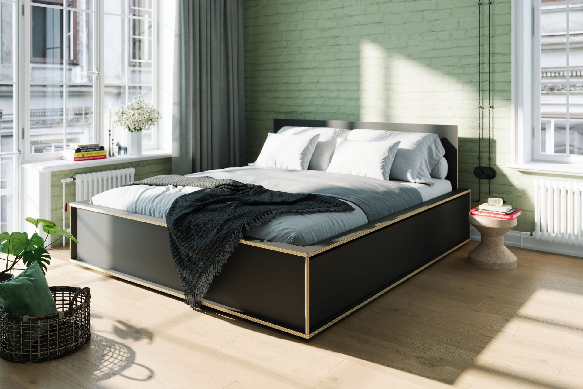 Schlafzimmer Interieur mit Spaze Bett von Müller Möbelwerkstätten, schwarzer Rahmen, helle Bettwäsche und Tagesdecke.