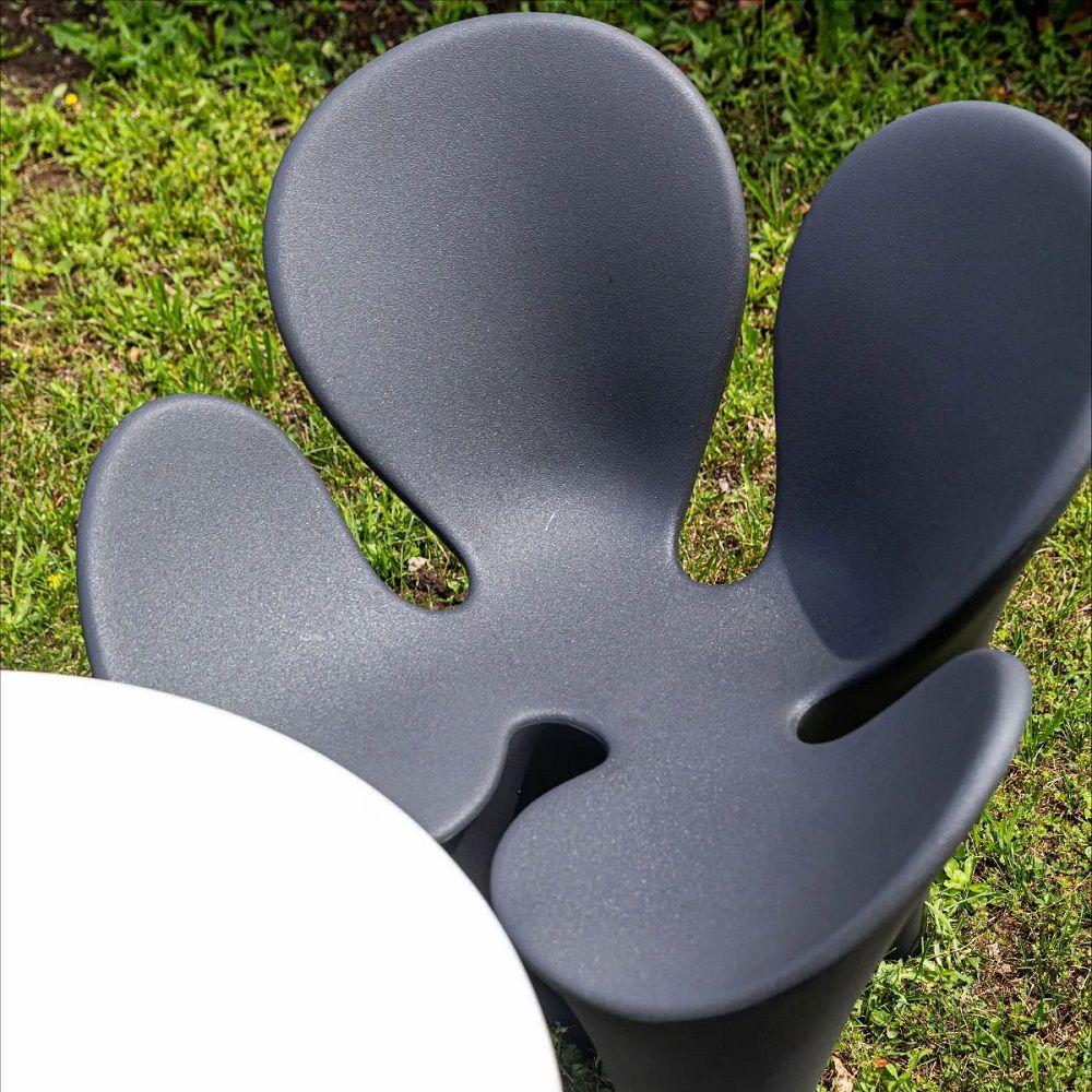 Nahaufnahme des grauen Clover Chair von Driade, ein moderner Armlehnstuhl für Garten und Terrasse.