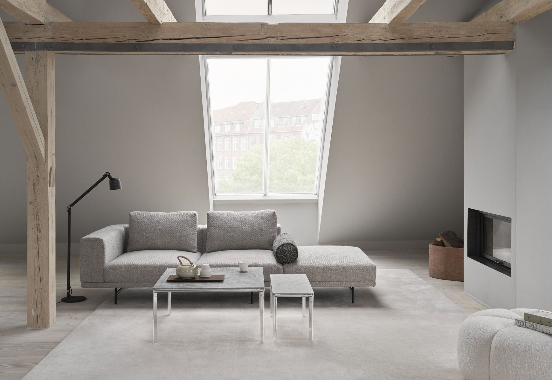 Vipp Coffee Table Square im modernen Wohnzimmer mit grauem Sofa und Kamin.