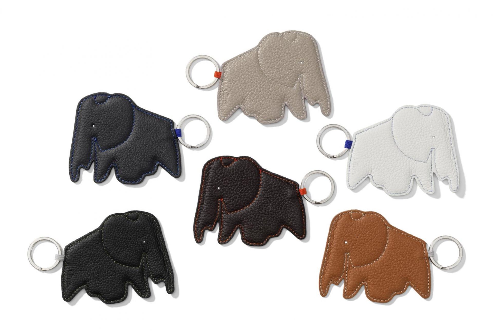 Mehrere farbige Elefanten-Schlüsselanhänger aus Leder, inklusive des schwarzen "Elephant Vitra Nero" Schlüsselanhängers.