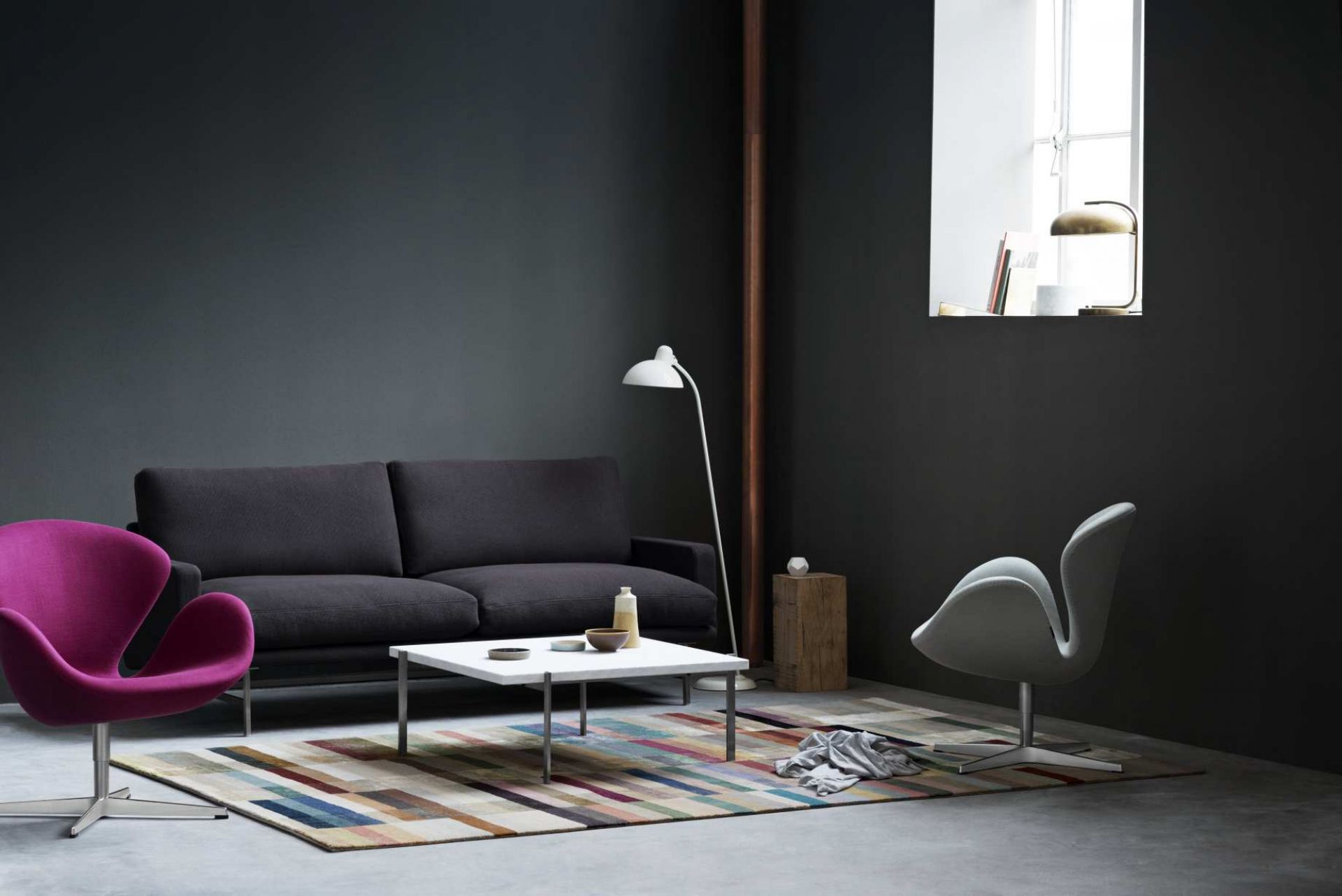 Dunkelgraues Lissoni Sofa von Fritz Hansen in modernem Wohnzimmer mit Teppich und Designermöbeln.