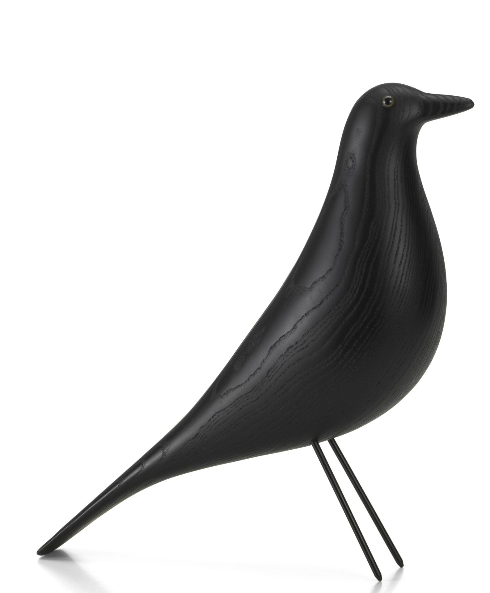Eames House Bird von Vitra, eine dekorative Vogelskulptur aus schwarzem Eschenholz auf filigranem Drahtgestell.