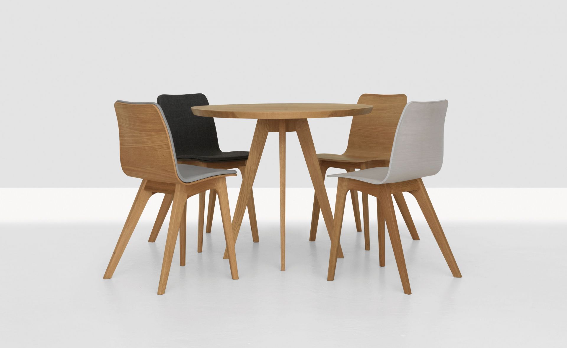 CENA Tisch, runder Esstisch aus Holz mit vier Stühlen in verschiedenen Farben.