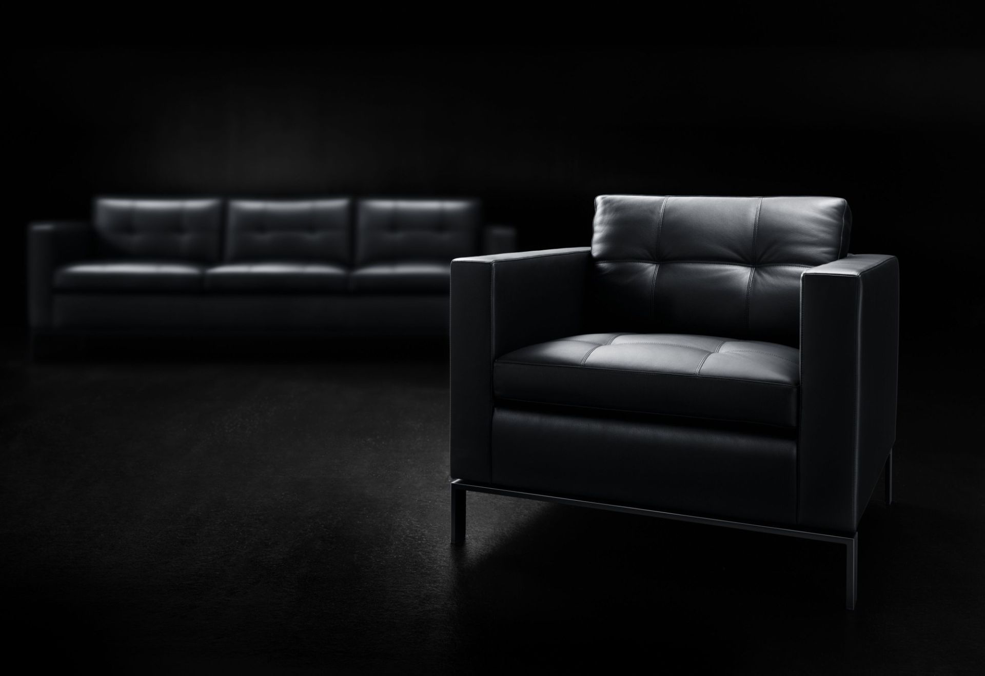 Schwarzer 502 Foster Sessel von Walter Knoll mit Lederbezug und Metallbeinen vor dunklem Hintergrund.