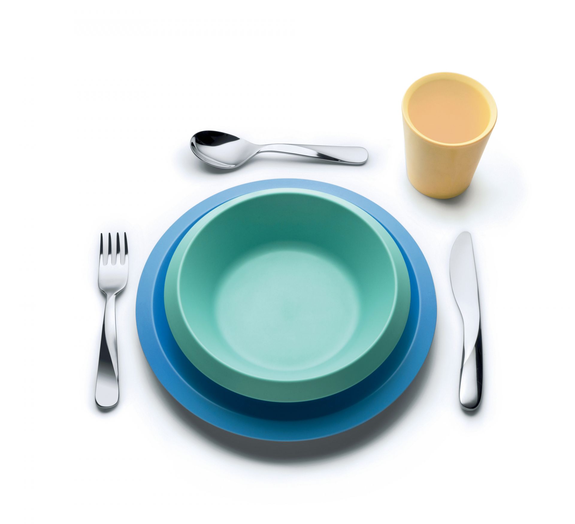 Alessi Kindergeschirr Set: Teller, Schüssel, Becher und Besteck in fröhlichen Farben.