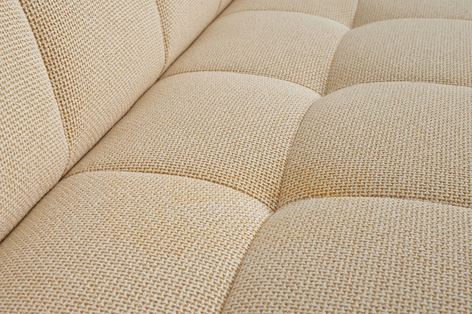 Detailaufnahme des beigen Stoffbezugs vom Quilton Sofa von Hay, ein modernes Polstermöbel für Wohnzimmer.
