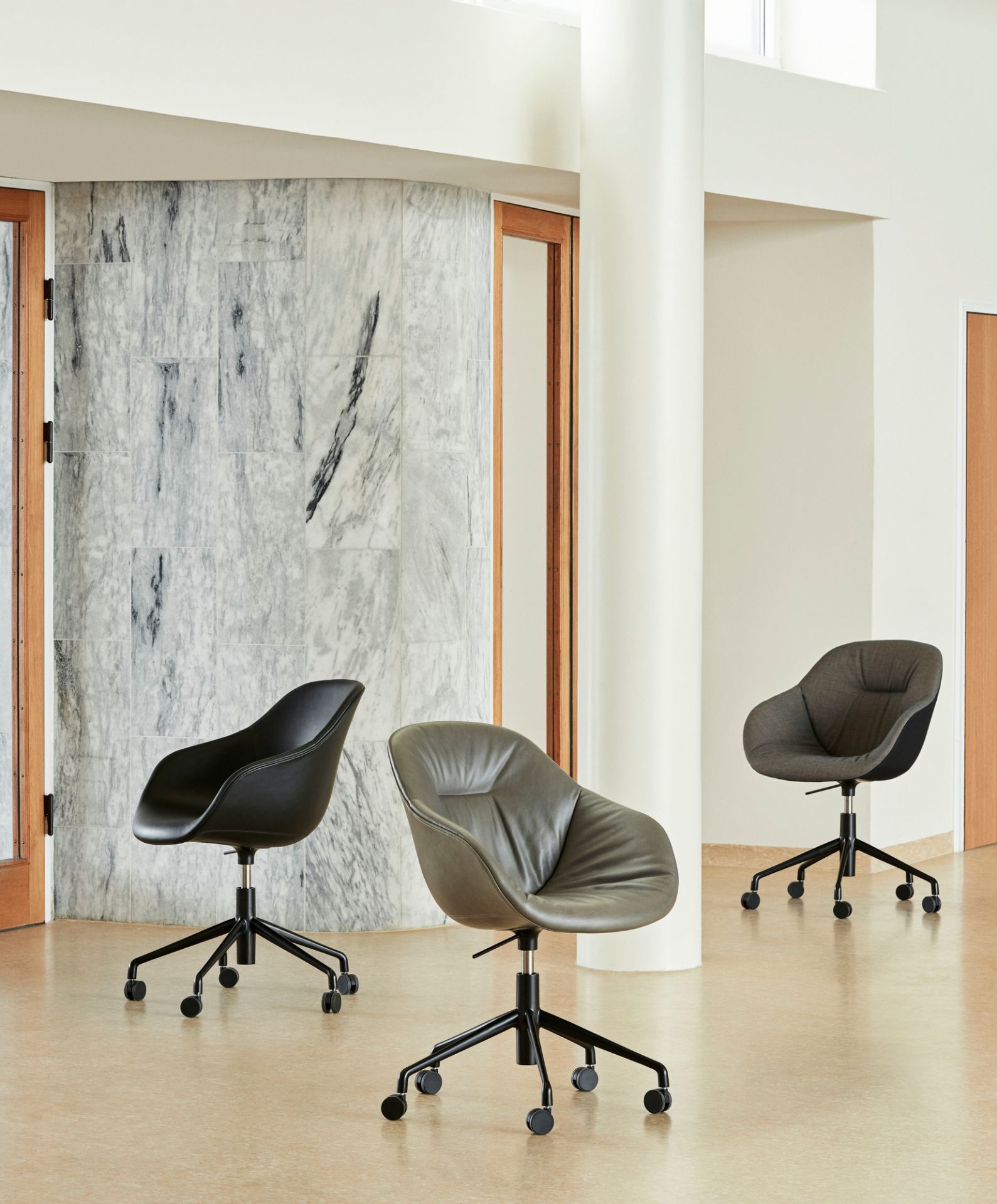 Drei Hay About a Chair AAC153 Soft Duo Bürostühle in Schwarz, Grau und Leder mit Rollen.