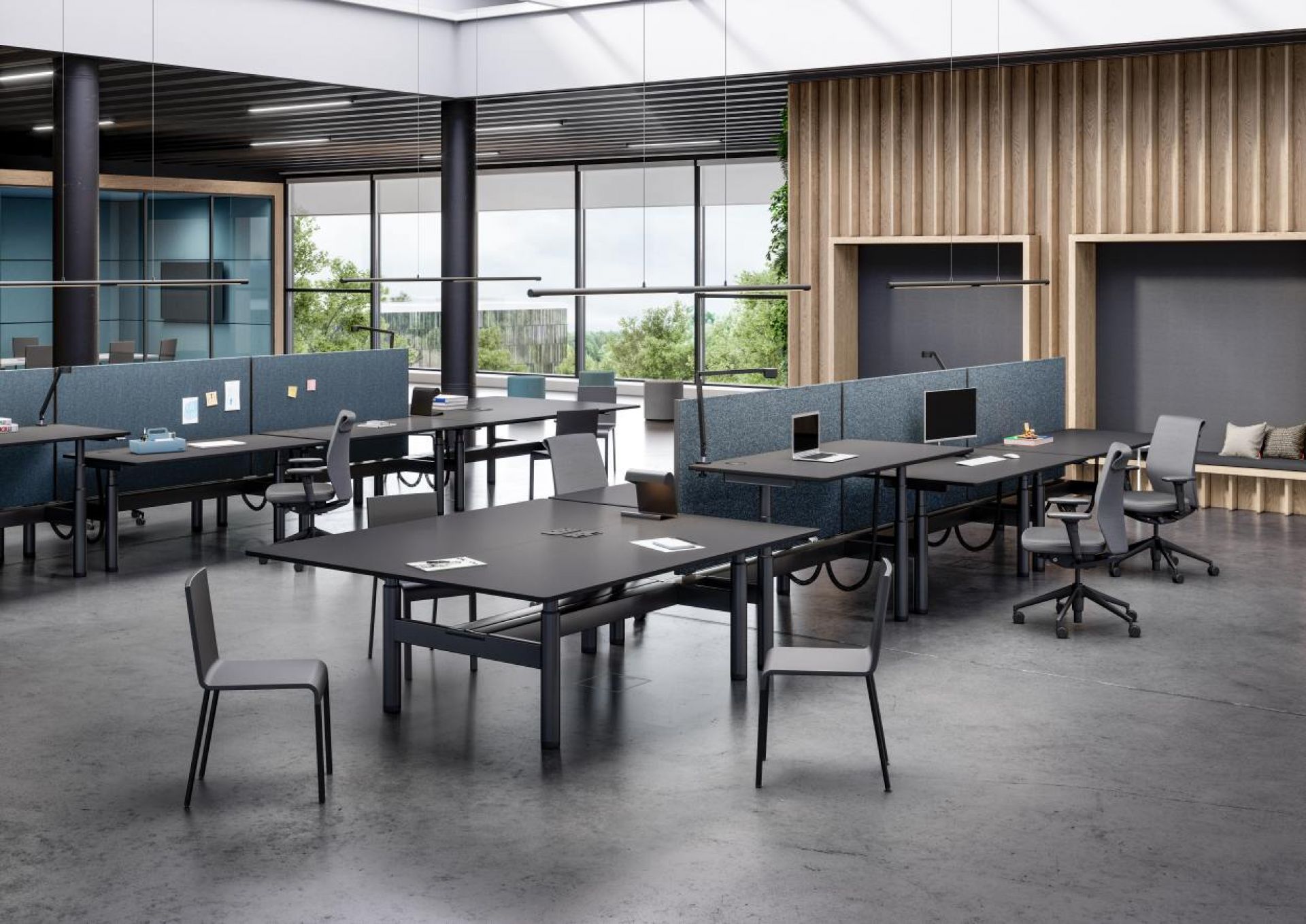 Modernes Großraumbüro mit mehreren schwarzen Tyde Sitz- und Stehtischen von Vitra, höhenverstellbar für ergonomisches Arbeiten.