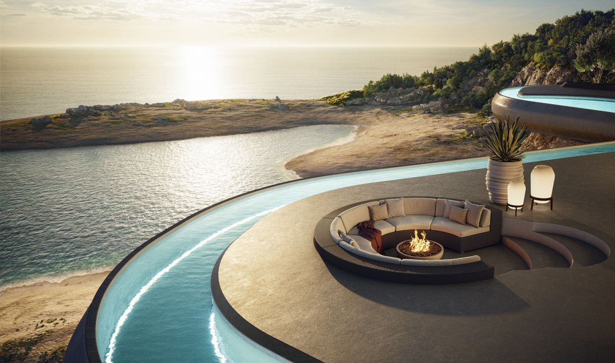 Luxuriöse Lounge-Ecke mit Polster und Feuerstelle, möglicherweise Dedon, mit Meerblick und Pool.