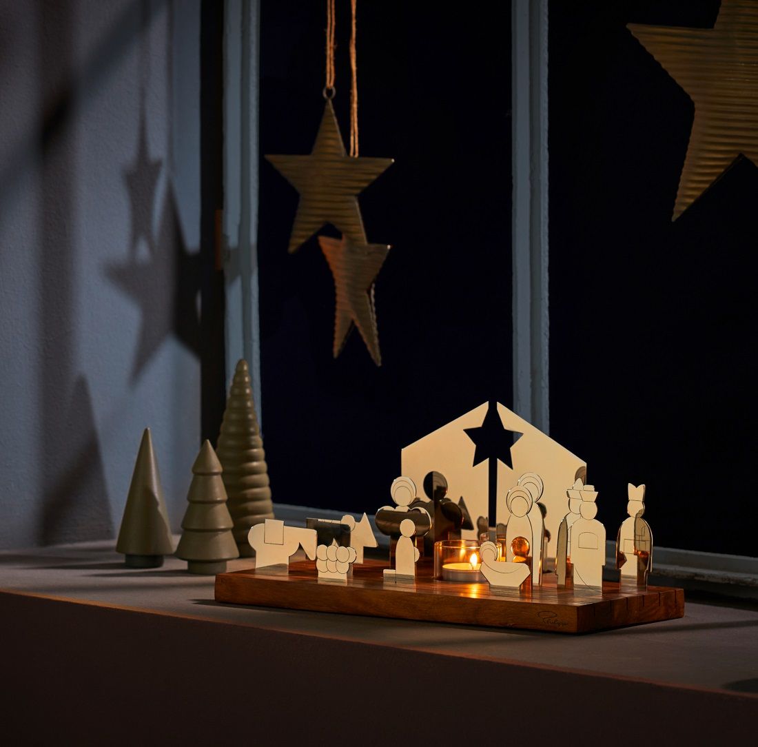 Philippi Bethlehem Krippe aus Edelstahl auf Holztablett mit Kerze und Weihnachtsdekoration.