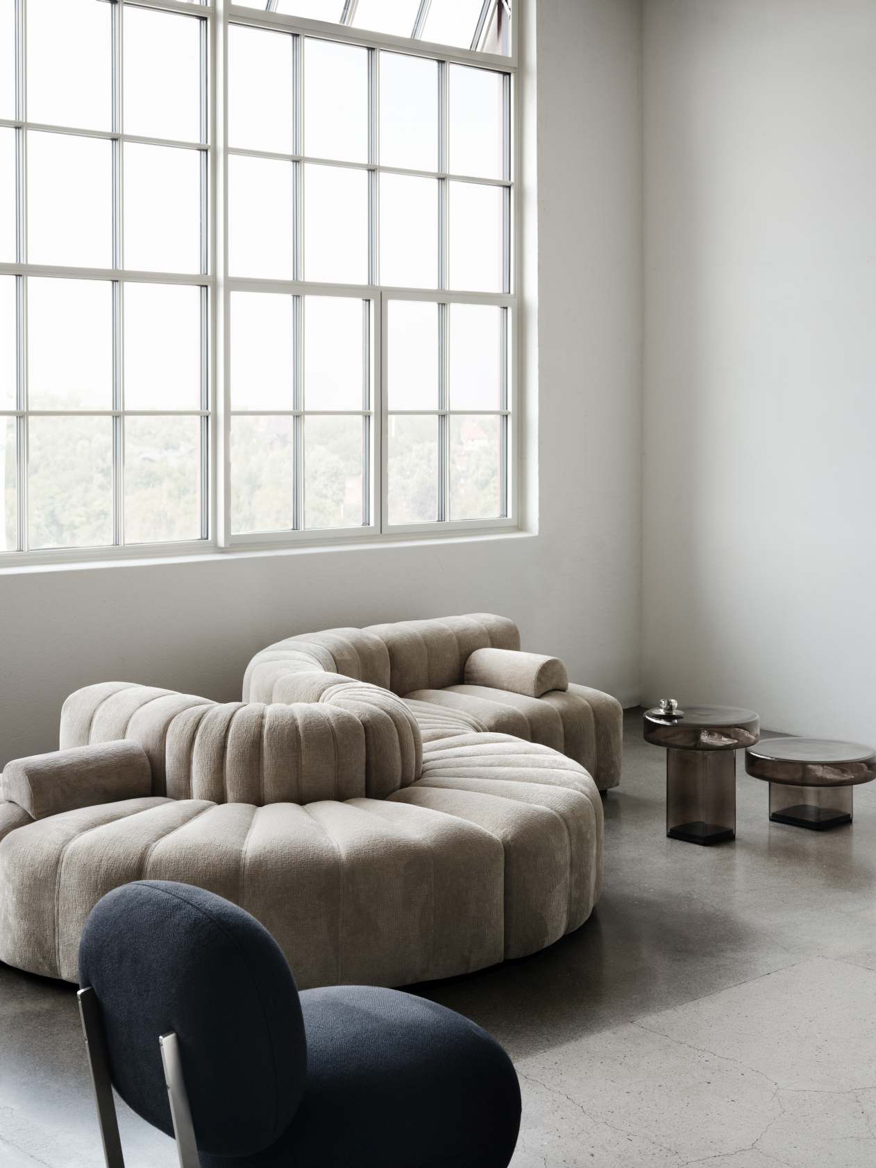 NORR11 Copper Lounge Chair Sessel mit Edelstahlgestell in modernem Wohnraum, ergänzt durch modulare Couch.