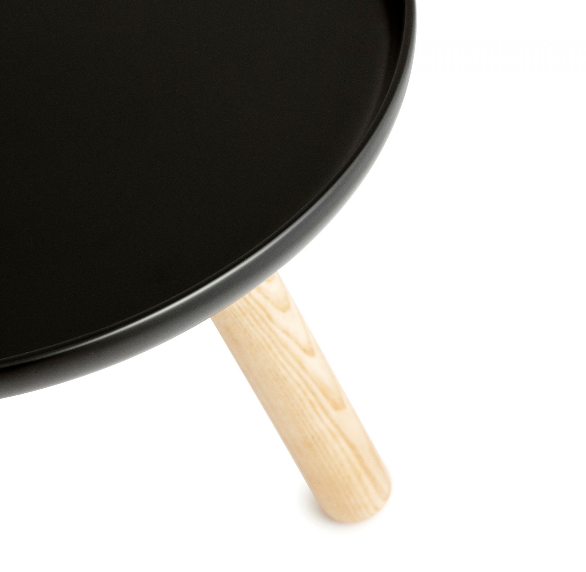 Detailaufnahme: Schwarzer Tablo Couchtisch von Normann Copenhagen mit hellem Holzbein.