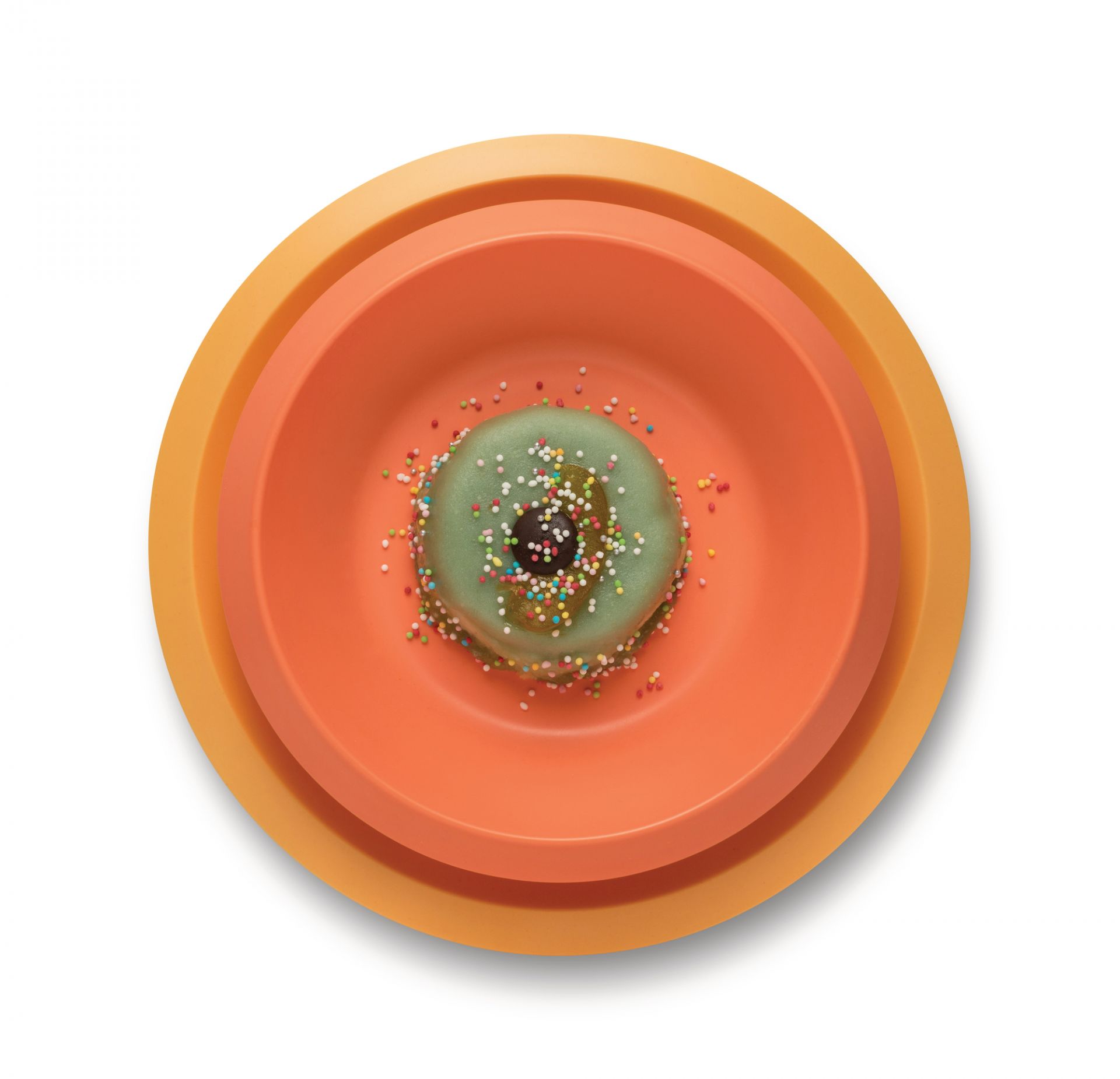Alessi Kindergeschirr Giro Kids Collection: Teller-Set in Orange- und Gelbtönen mit Donut.