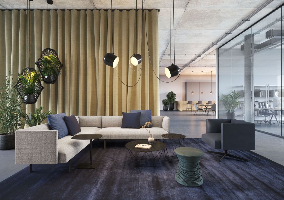 Muud Lite Sofa von Walter Knoll in modernem Büroambiente mit blauen Kissen und Teppich.